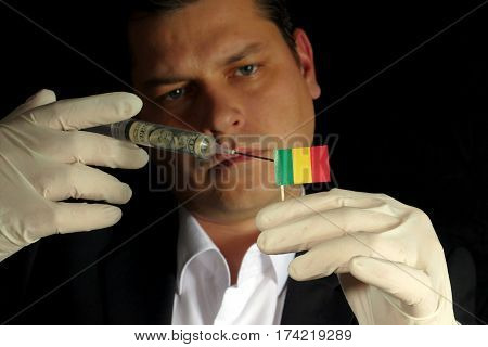 Young Businessman Gives A Financial Injection To Malian Flag Isolated On Black Background