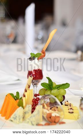 Red and white dessert wines fruit cheeses on the buffet table