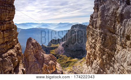 via ferrata, sunny morning in the mountains. Dolomites, green valley. Alps
