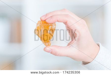 Honey calcite semi preciouse gemstone in hand