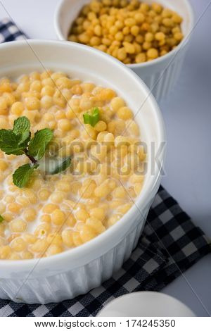 Dahi Bundi or Boondi Raita, favourite indian started or side dish made using Rajasthani snack food made from sweetened, fried chickpea flour, called Boondi with sweet and salty curd or buttermilk