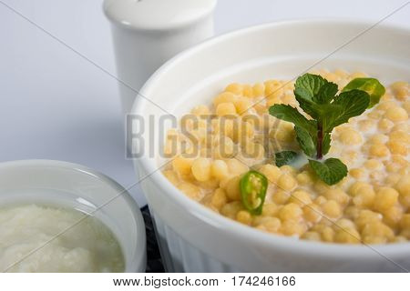 Dahi Bundi or Boondi Raita, favourite indian started or side dish made using Rajasthani snack food made from sweetened, fried chickpea flour, called Boondi with sweet and salty curd or buttermilk