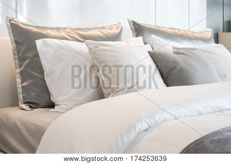 Gray Color Scheme Pillows Setting On Bed With Satin Finished Style Bedding