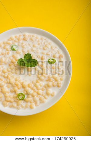 Dahi Bundi or Boondi Raita, favourite indian started or side dish made using Rajasthani snack food made from sweetened, fried chickpea flour, called Boondi with sweet and salty curd or buttermilk