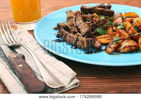 Homemade Slow Cooked Beef with Potatoes on wooden background