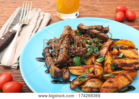 Homemade Slow Cooked Beef with Potatoes on wooden background