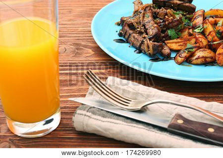 Homemade Slow Cooked Beef with Potatoes on wooden background