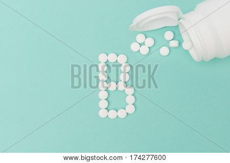 Bottle With Vitamin B Pills Forming The Letter 'b'