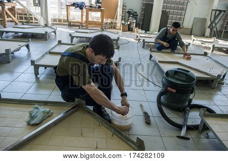 Workers Assemble Shower Cabins Ship