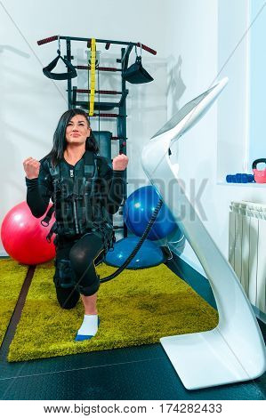 The female athlete doing they exercise in the EMS fitness studio
