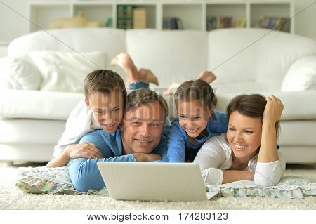 big happy family watching something on laptop