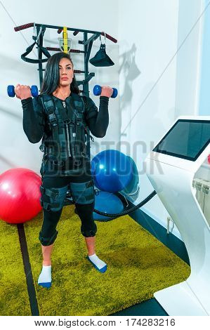 The female athlete doing they exercise in the EMS fitness studio