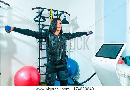 The female athlete doing they exercise in the EMS fitness studio