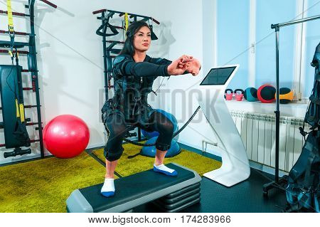 The female athlete doing they exercise in the EMS fitness studio