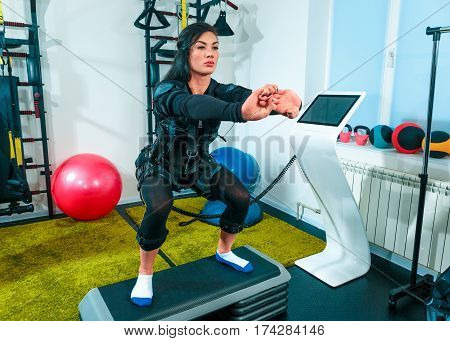The female athlete doing they exercise in the EMS fitness studio