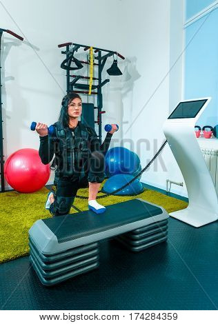 The female athlete doing they exercise in the EMS fitness studio