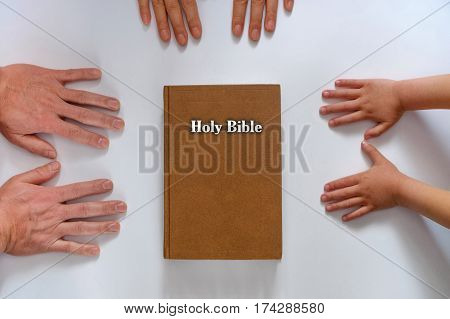 family bible hands on a white background