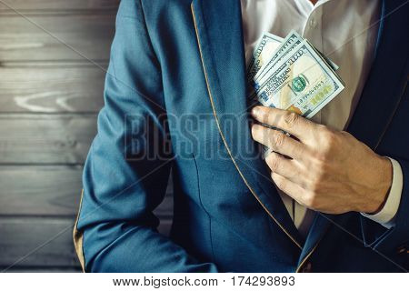 Businessman, Member Or Officer Puts A Bribe In His Pocket