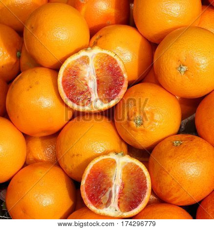Oranges And An Orange Cut In The Stall Of Greengrocer