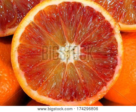 Ripe Oranges And An Orange Cut In The Stall Of Greengrocer