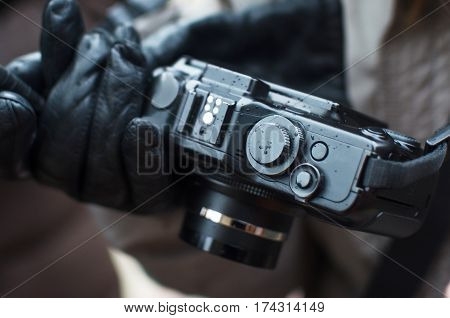 compact camera on the street in the hands with raindrops