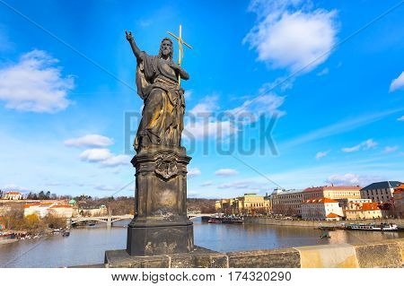 Statue at Charles Bridge in Prague, historic buildings panorama