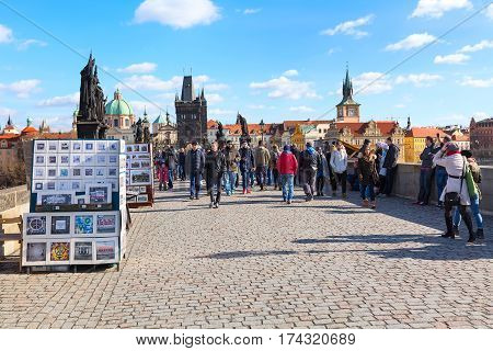Prague, Czech Republic - February 25, 2017: People at Charles Bridge in Prague, historic buildings panorama