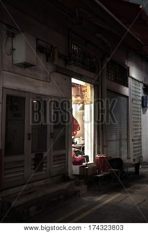 Back alley with open door the the kitchen of a small restaurant