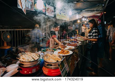 CHIANG MAI THAILAND - AUGUST 27: Thai woman sales at the Saturday Night Market on August 27 2016 in Chiang Mai Thailand.
