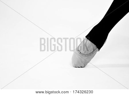 black and white photo of ballet dancer foot on a white background
