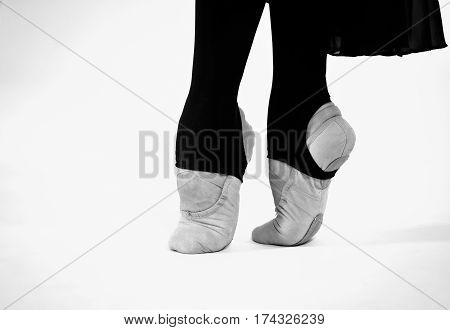 black and white photo of ballet dancer feet on a white background