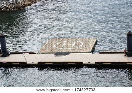Helicopter Pad on Wood Pier in Harbor