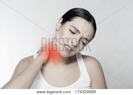 health people Sport and lifestyle concept - Tired Neck. Beautiful Young Woman Suffering From Neck Pain. Attractive Female Feeling Tired Exhausted Stressed. Girl Massaging Painful Neck With Hand.