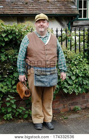 IRONBRIDGE UK - CIRCA 2013: Tradesman in traditional costume at Blists Hill Victorian Museum. Ironbridge Shropshire UK