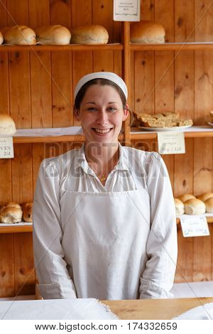 IRONBRIDGE UK - CIRCA 2013: Woman baker at the Victorian Bakery shop store in Blists Hill Museum Ironbridge Shropshire UK
