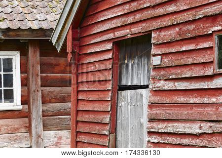 Traditional norwegian wooden red colored cabin houses facades. Otternes Norway