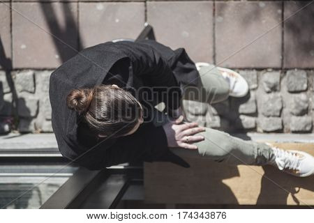 A girl resting in the street bar window waiting for coffee