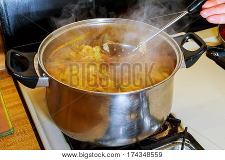 Borsch with garlic vegetable soup on the wood plate board on the left side Ukrainian borsch cooking