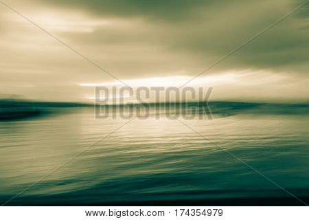 Dreamy motion blur in split tones at sunset over the bay Russell New Zealand.