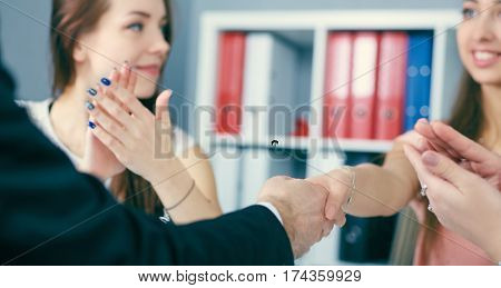 Close up of business handshake in the office. Serious business and partnership concept. Partners made deal sealed with handclasp.