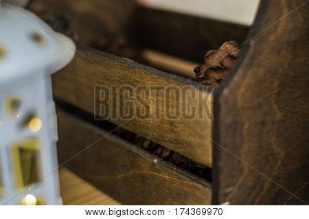 Wooden box with a pine cone and latern