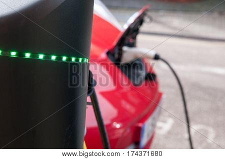electric car charging to refuel at the charge station