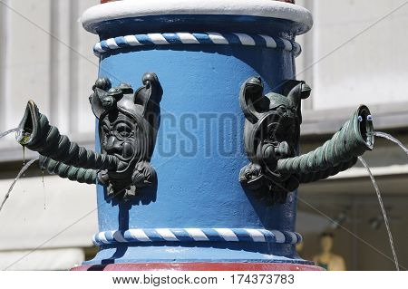 LUCERNE SWITZERLAND - MAY 06 2016: Fritschi Fountain detail that is a part of a pillar. There are a few taps from which bodies the water flows out.