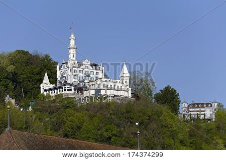 LUCERNE SWITZERLAND - MAY 05 2016: Gutsch castle on a sunny day. The building houses hotel and restaurant with its unique architecture and its location makes it one of the tourist attractions.