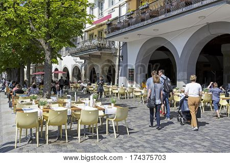 Lucerne Switzerland - May 08 2016: Outdoor seating restaurant. There are still places available but there are also people who are already seated at tables some people go.
