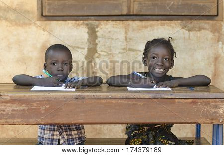 Two african children smiling and studying in school in Bamako Mali.