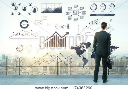 Thoughtful young businessperson on rooftop with abstract business sketch. City view in the background. Success concept