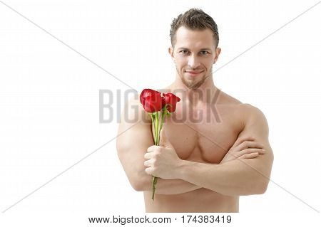 Handsome man holding a red rose and a bouquet of red roses. Sexy man gives a rose on a white background with a beautiful light. Isolated on white background