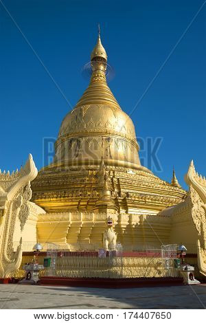 The old stupa of Buddhist temple Maha Wizaya Pagoda close up against the background of the blue sky. Yangon, Myanmar