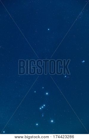 Milky way stars Orion and Pleiades on a night sky.